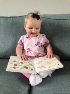 A picture of a child reading a braille book