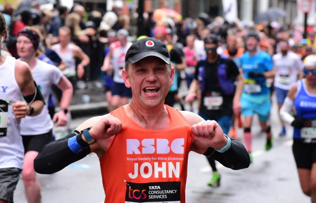 A man in the crowd wearing the RSBC orange vest
