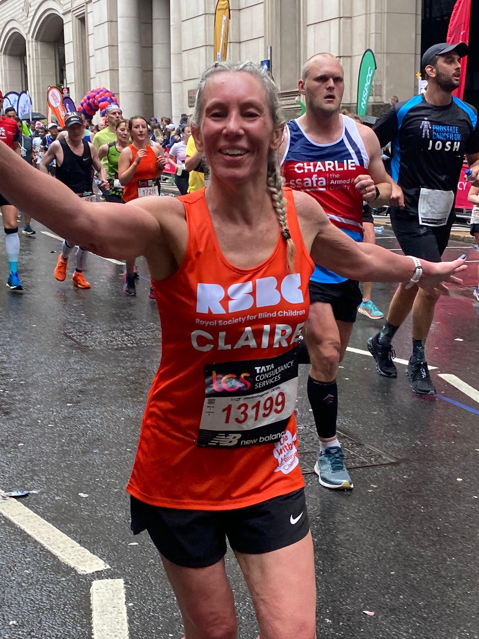 A woman in the crowd wearing the RSBC orange vest