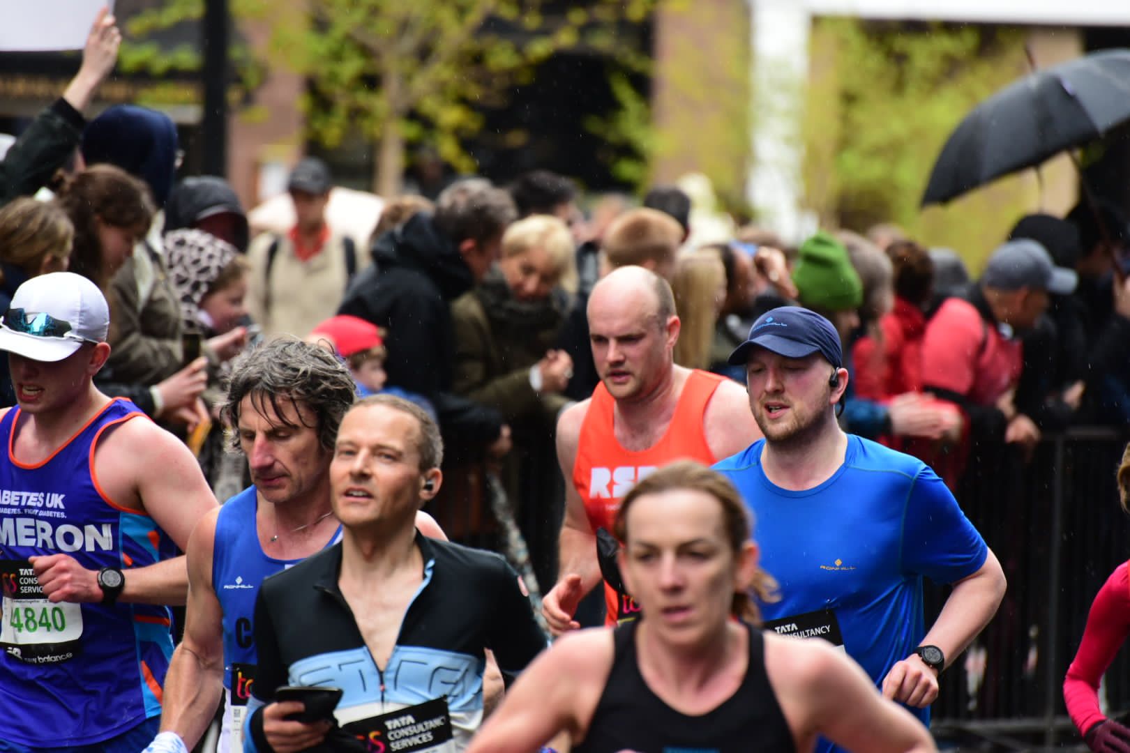 A man in the crowd wearing the RSBC orange vest