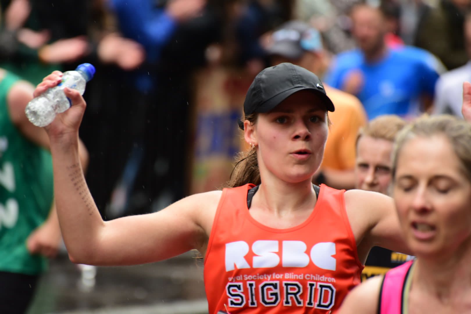 A woman in the crowd wearing the RSBC orange ves