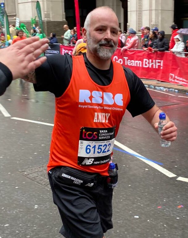 A man giving a hand check. He's wearing RSBC orange vest