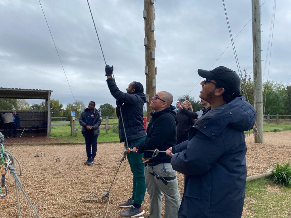 A group of VI young people on an RSBC residential trip, preparing to rock climb.